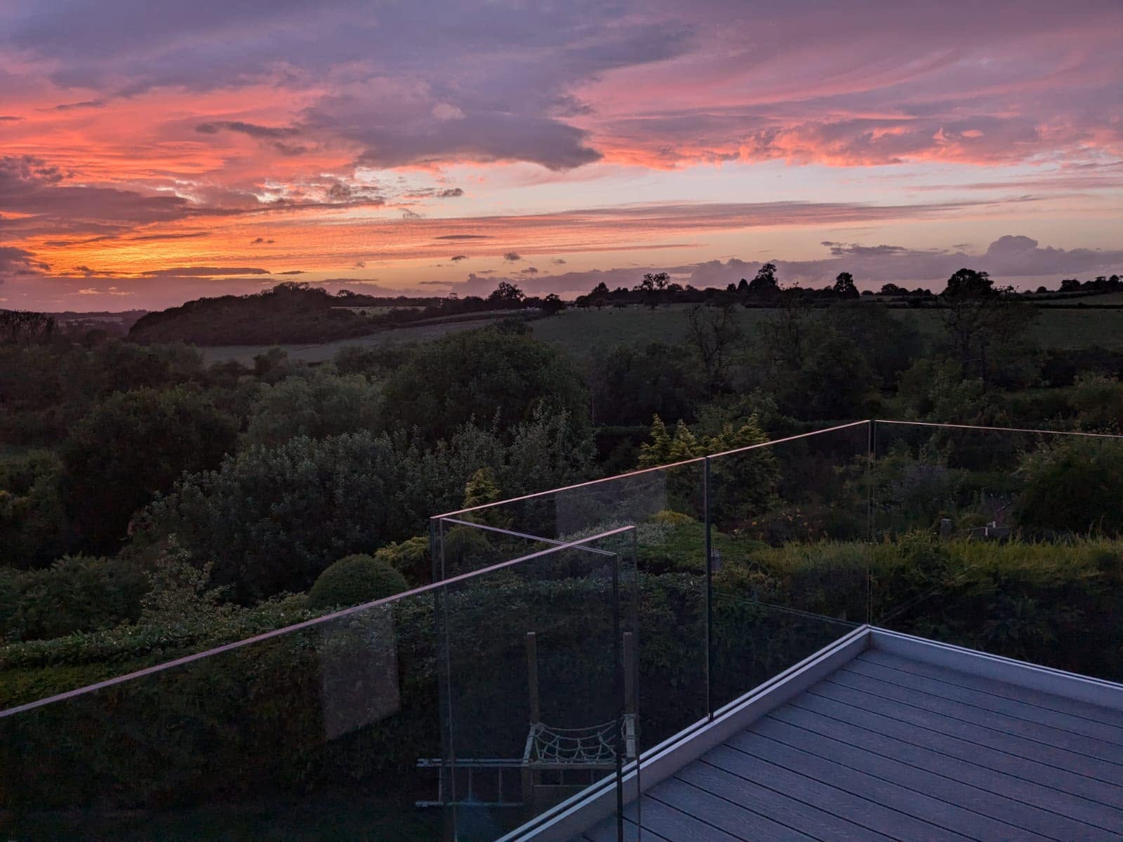 Balcony glass balustrade with a sunset in the background