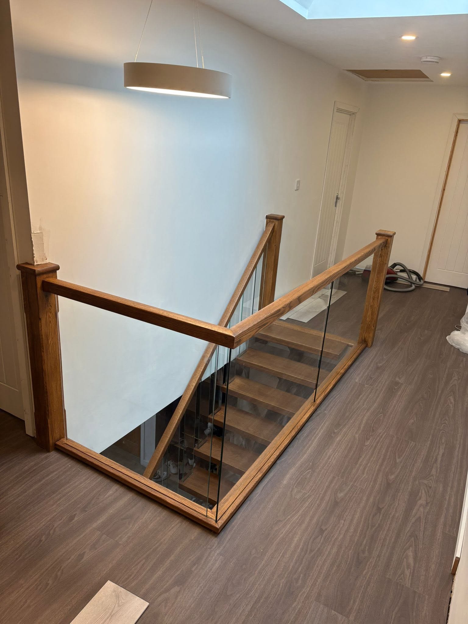 Custom staircase detailing featuring natural wood grain and precision joinery
