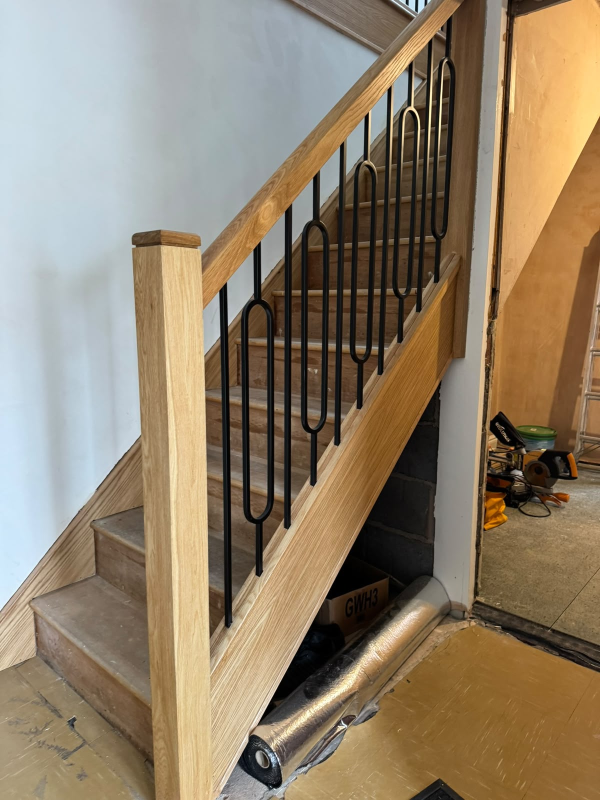 Bespoke oak staircase with a matching wooden handrail
