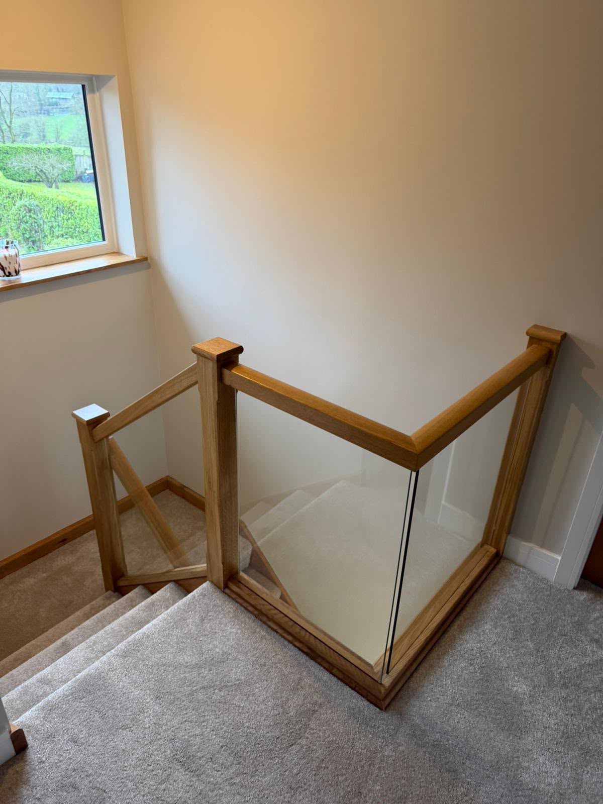 Bespoke staircase installation featuring oak treads and clear glass panels