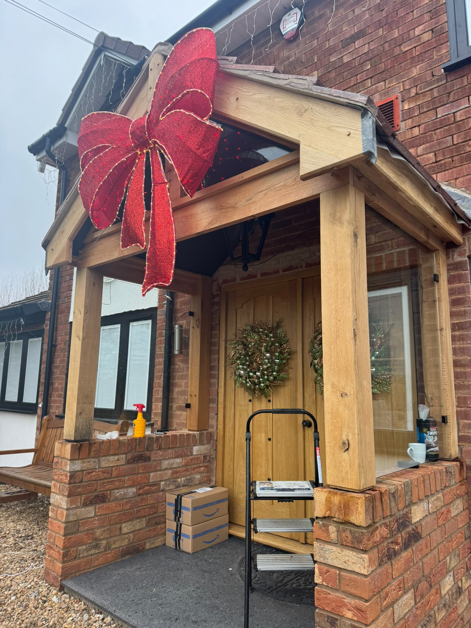 Timber porch extension with a pitched roof and decorative wooden supports